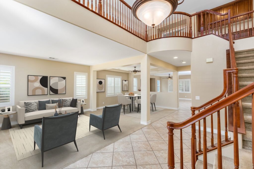 Spacious living area featuring modern furniture, decorative art, and a staircase, showcasing an inviting home environment.